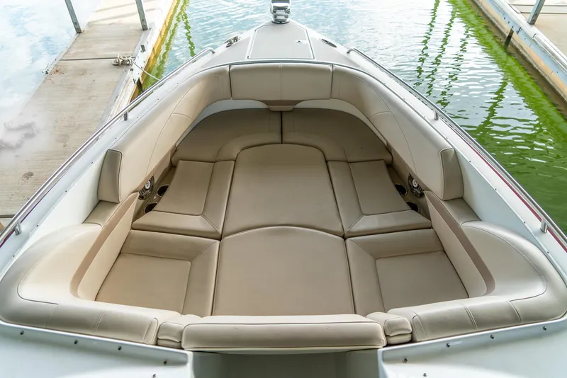 Slide: The Image of 2012 Formula 310 Bowrider boat with spacious beige seating at dock. - 32