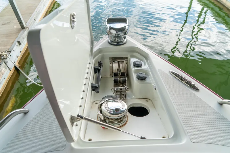 Slide: The Image of 2012 Formula 310 Bowrider anchor compartment with open hatch, dockside view. - 33