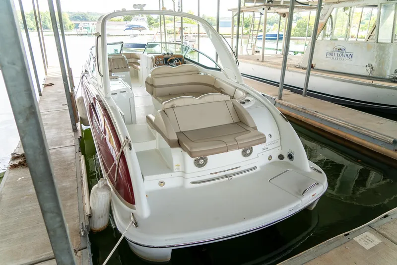 Slide: The Image of 2012 Formula 310 Bowrider docked at marina, featuring spacious seating and sleek design. - 8
