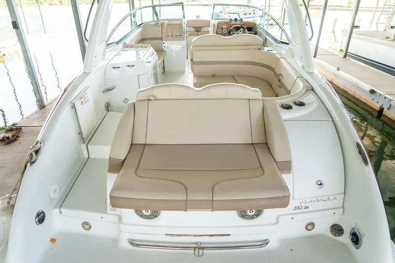 Slide: The Image of 2012 Formula 310 Bowrider boat interior with beige seating and modern dashboard. - 9