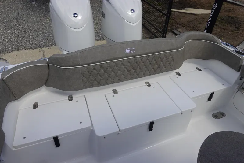 Slide: The Image of 2026 Sea Hunt Ultra 265 SE boat seating area with storage compartments. - 11