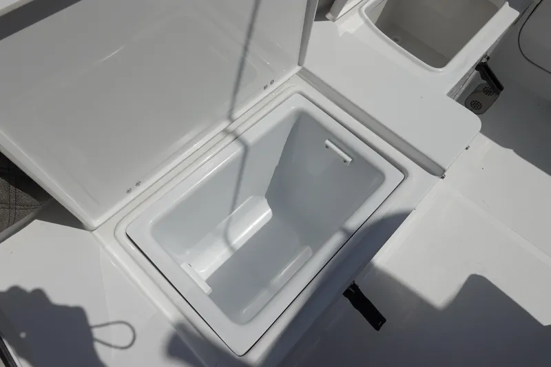 Slide: The Image of Open storage compartment on 2026 Sea Hunt Ultra 265 SE boat deck. - 14