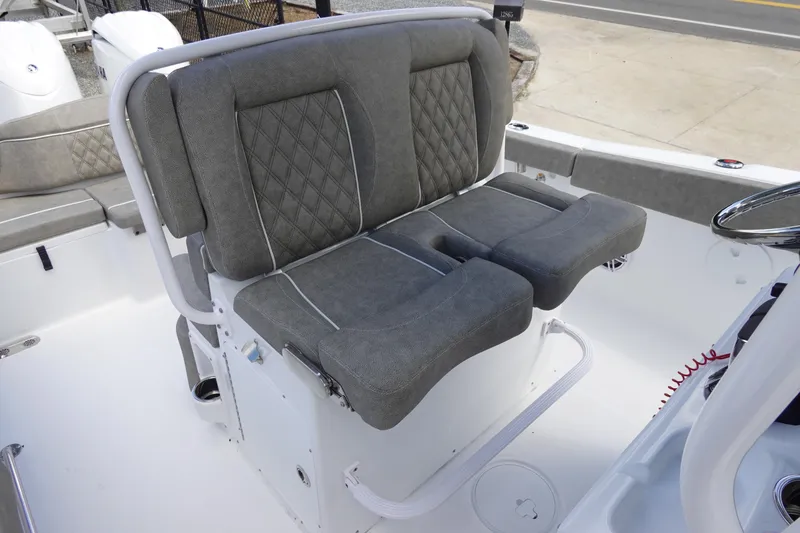 Slide: The Image of 2026 Sea Hunt Ultra 265 SE boat seating with gray cushioned seats and white frame. - 21