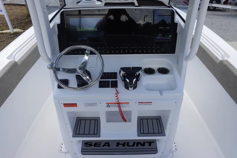 Slide: The Image of 2026 Sea Hunt Ultra 265 SE boat console with Garmin display and steering wheel. - 22