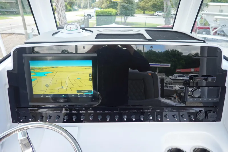 Slide: The Image of 2026 Sea Hunt Ultra 265 SE dashboard with Garmin navigation display and control panel. - 23