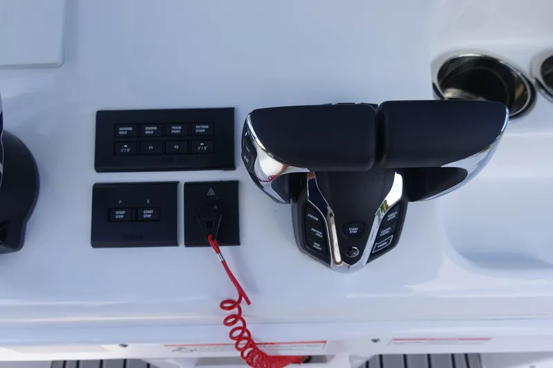 Slide: The Image of Control panel of 2026 Sea Hunt Ultra 265 SE boat with throttle and switches. - 26
