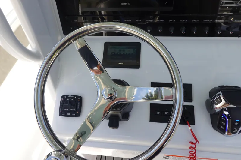 Slide: The Image of Steering wheel and controls of 2026 Sea Hunt Ultra 265 SE boat. - 27