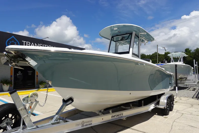 Slide: The Image of 2026 Sea Hunt Ultra 265 SE boat on trailer, displayed outdoors under a blue sky. - 3