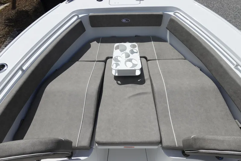 Slide: The Image of 2026 Sea Hunt Ultra 265 SE boat with cushioned seating and cup holders. - 33