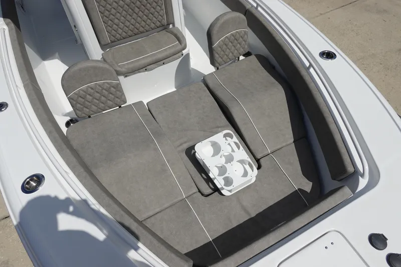 Slide: The Image of 2026 Sea Hunt Ultra 265 SE boat interior with gray cushioned seating and cup holder. - 34