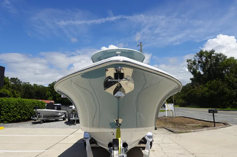 Slide: The Image of 2026 Sea Hunt Ultra 265 SE boat on trailer, front view under clear blue sky. - 4