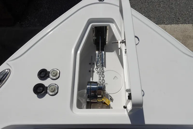 Slide: The Image of Anchor compartment of 2026 Sea Hunt Ultra 265 SE boat, featuring chain and winch. - 40