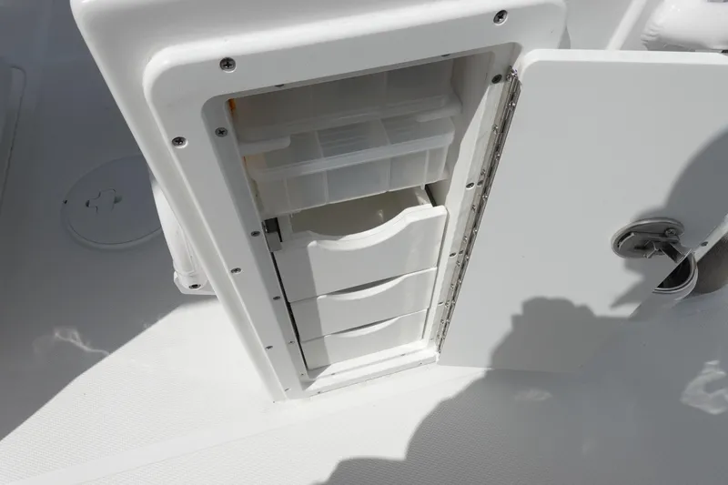 Slide: The Image of Storage compartment on 2026 Sea Hunt Ultra 265 SE boat, featuring organized drawers. - 43