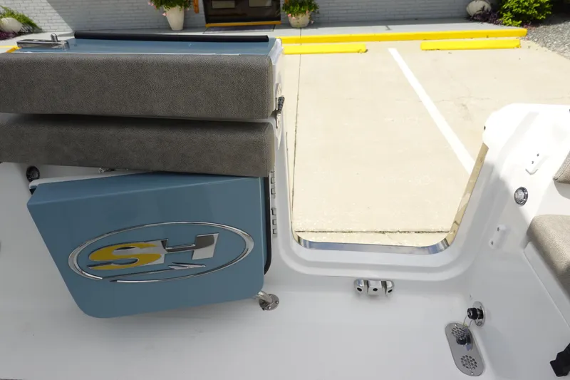 Slide: The Image of Sea Hunt Ultra 265 SE 2026 boat interior with cushioned seating and logo detail. - 46