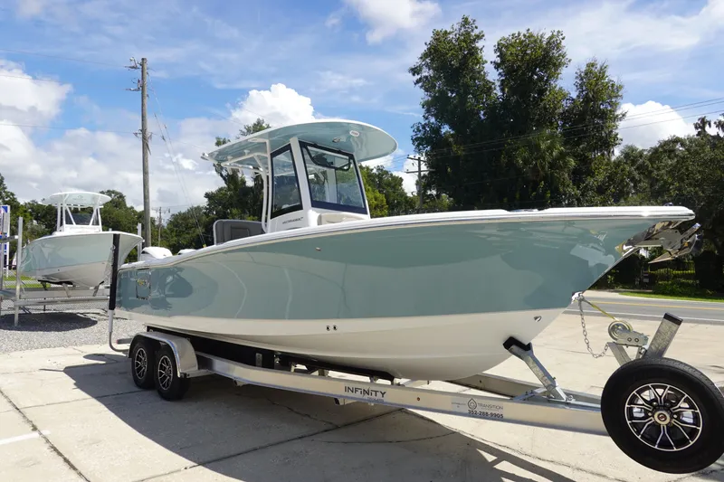 Slide: The Image of 2026 Sea Hunt Ultra 265 SE boat on trailer, displayed outdoors under a clear sky. - 5