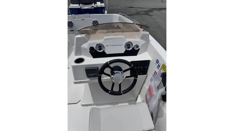 Slide: The Image of 2025 Starcraft SVX 171 OB boat dashboard with steering wheel and controls. - 5