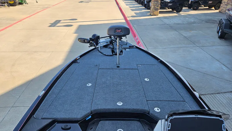 Slide: The Image of 2025 Ranger Z520 boat deck with seating and equipment, parked outdoors. - 4