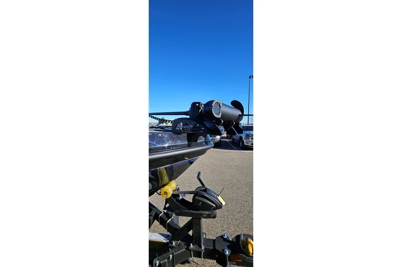 Slide: The Image of 2025 Nitro ZV20 boat trailer with motor, parked under clear blue sky. - 7
