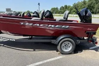 The Image of 2025 Tracker Super Guide V-16 T boat on trailer, parked outdoors. - 0