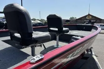 Slide: The Image of 2025 Tracker Super Guide V-16 T boat with red exterior and dual seating. - 2