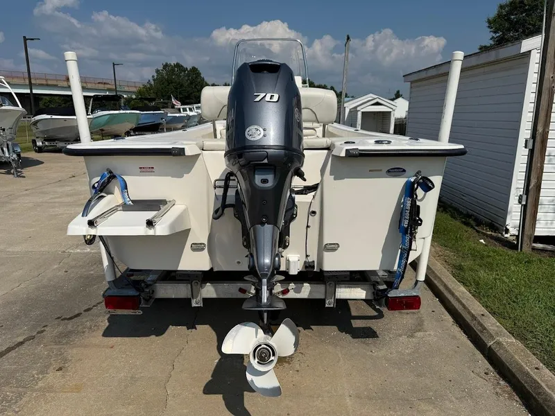 Slide: The Image of 2015 Key West 177 Skiff with 70 HP outboard motor, parked outdoors. - 3