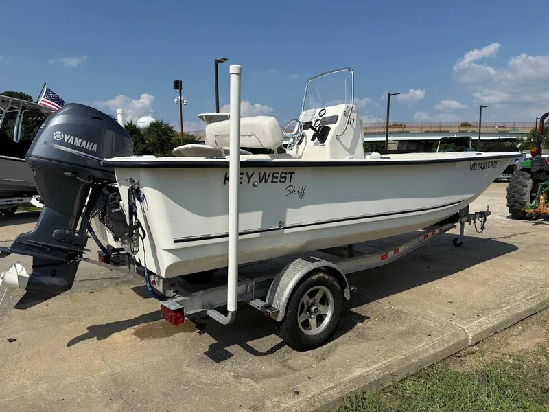 Slide: The Image of 2015 Key West 177 Skiff boat on trailer with Yamaha outboard motor, parked outdoors. - 4