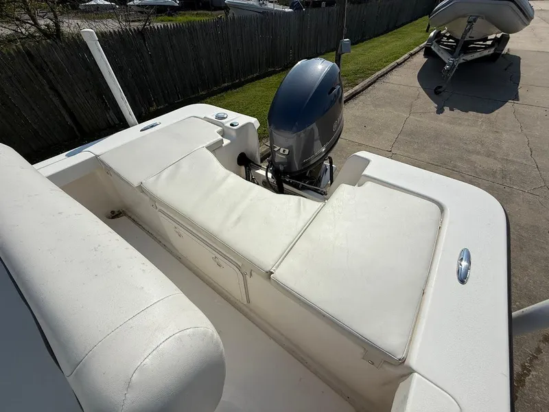 Slide: The Image of 2015 Key West 177 Skiff boat with outboard motor, parked on concrete. - 5