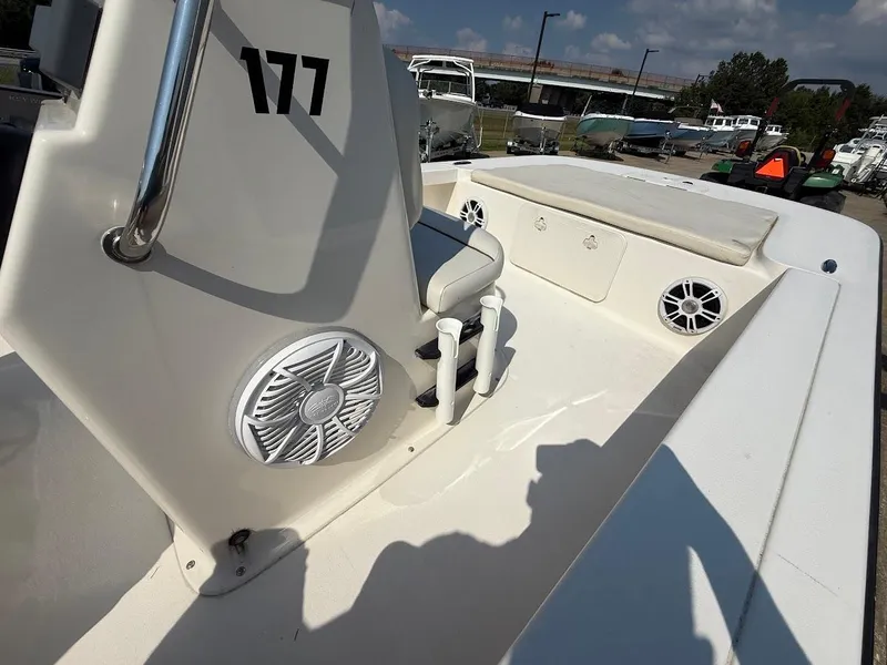 Slide: The Image of 2015 Key West 177 Skiff boat interior with seating and speakers, docked outdoors. - 8