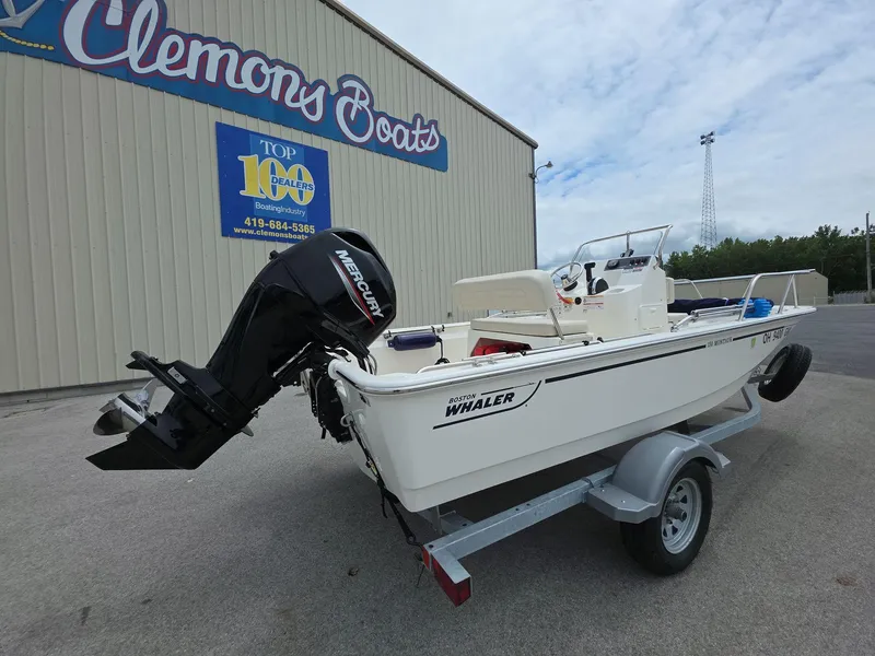 Slide: The Image of 2024 Boston Whaler 150 Montauk boat on trailer at Clemons Boats dealership. - 3