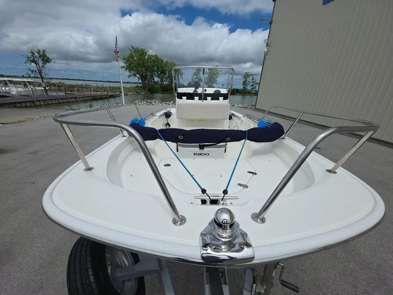 Slide: The Image of 2024 Boston Whaler 150 Montauk boat docked, showcasing sleek design and stainless steel railings. - 4