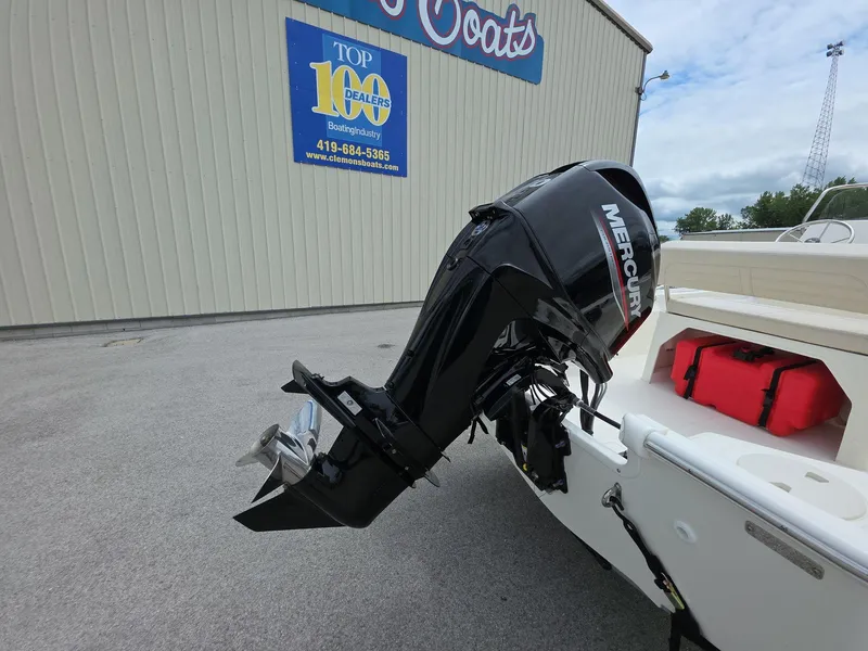 Slide: The Image of 2024 Boston Whaler 150 Montauk with Mercury outboard motor at dealership. - 6