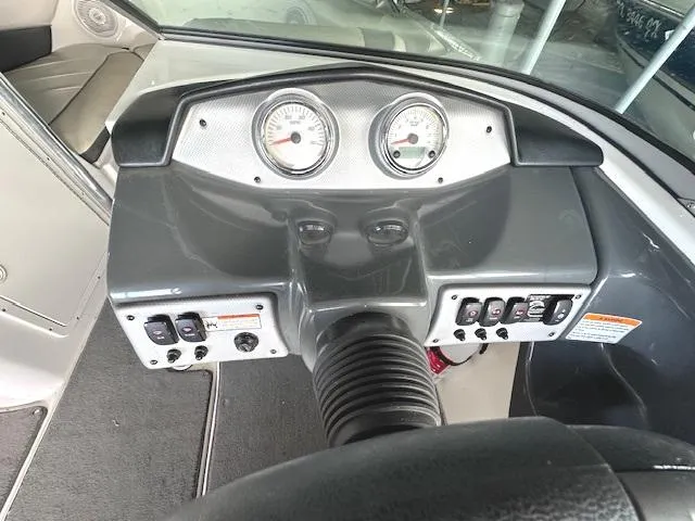 Slide: The Image of Dashboard of a 2014 Yamaha Boats SX190, featuring gauges and control switches. - 11