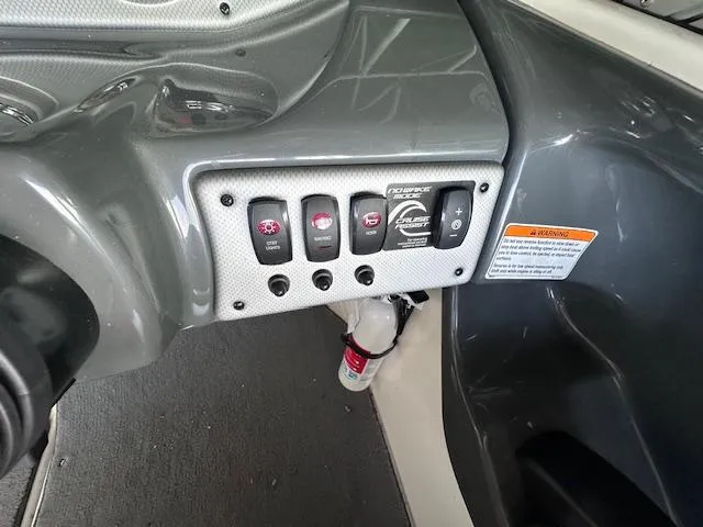 Slide: The Image of Control panel of a 2014 Yamaha Boats SX190 with switches and warning label. - 13