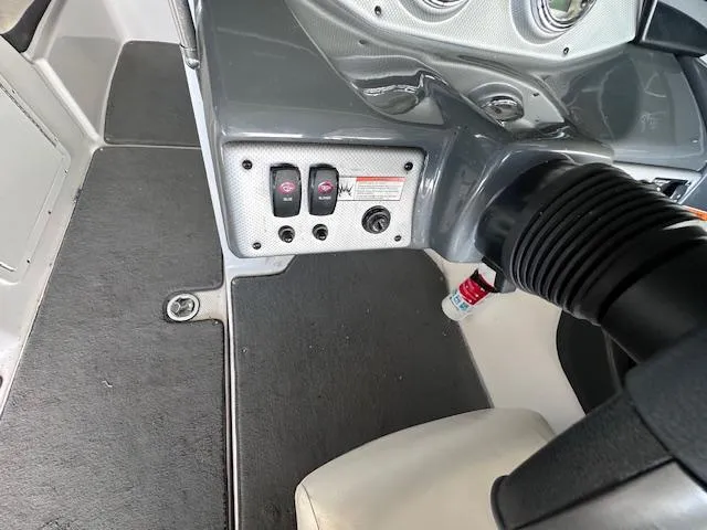 Slide: The Image of 2014 Yamaha SX190 boat interior dashboard with control switches and steering wheel. - 14