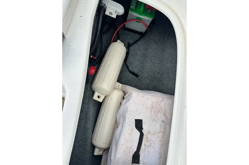 Slide: The Image of Storage compartment of a 2014 Yamaha SX190 boat with fenders and battery. - 17
