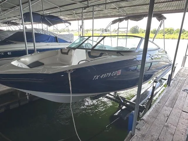 Slide: The Image of 2014 Yamaha Boats SX190 docked in a covered marina. - 2