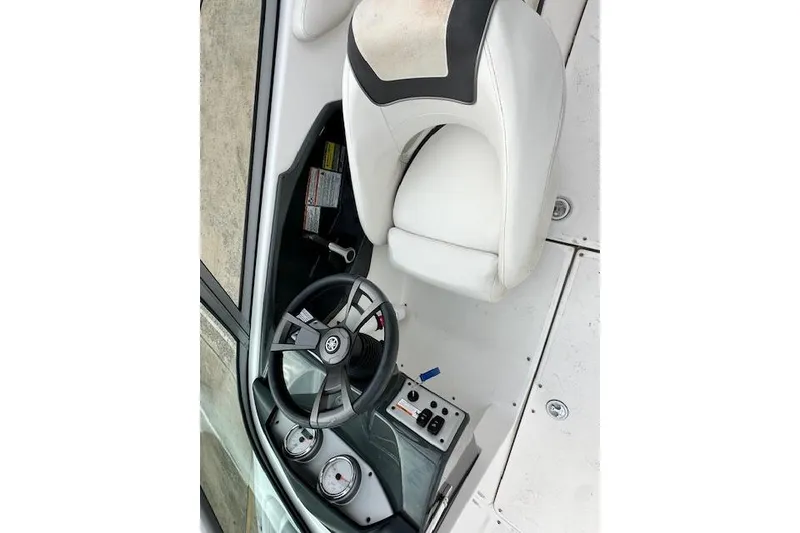Slide: The Image of 2014 Yamaha Boats SX190 cockpit with steering wheel and white seating. - 20
