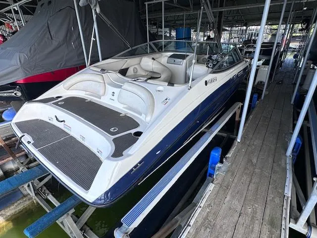 Slide: The Image of 2014 Yamaha Boats SX190 docked, showcasing sleek design and spacious seating. - 3