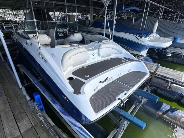 Slide: The Image of 2014 Yamaha Boats SX190 on dock, featuring sleek design and spacious seating. - 4