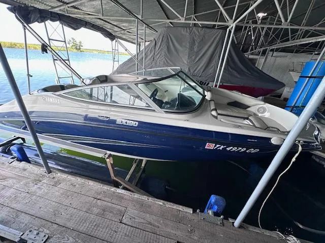 Slide: The Image of 2014 Yamaha SX190 boat docked under a covered marina. - 6