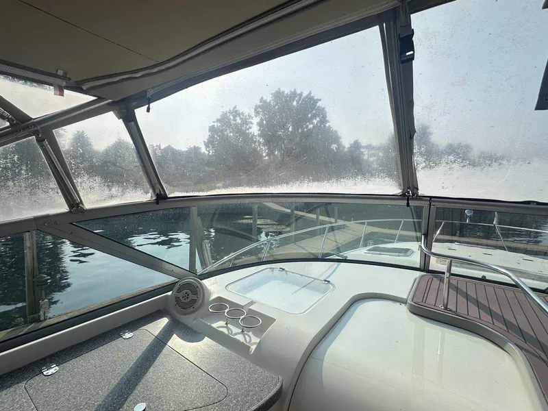 Slide: The Image of 2004 Rinker Fiesta Vee 410 boat interior with foggy windows and dock view. - 13