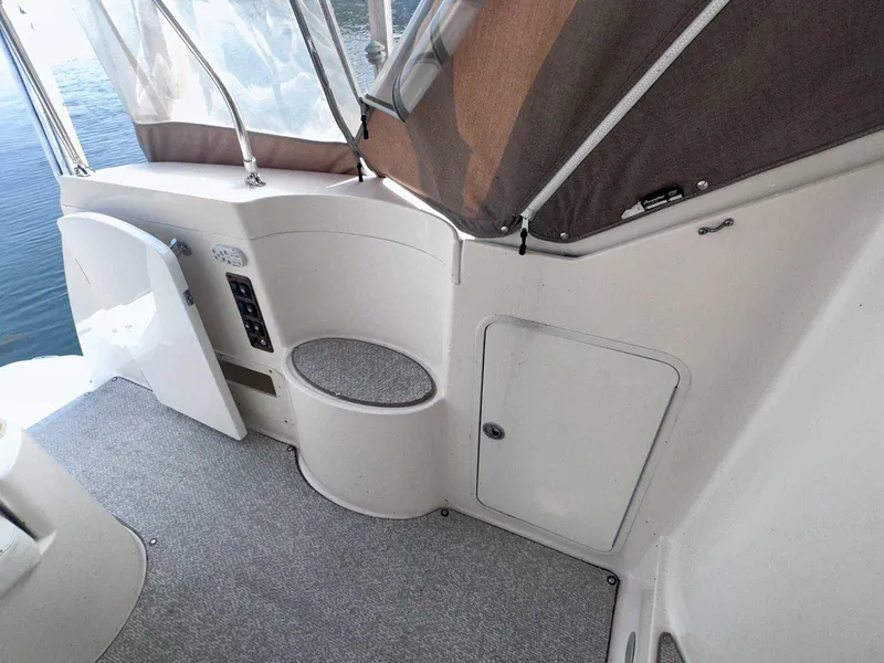 Slide: The Image of 2004 Rinker Fiesta Vee 410 boat interior with seating and storage compartments. - 2