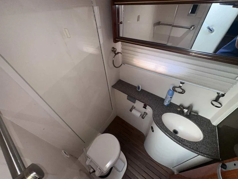 Slide: The Image of 2004 Rinker Fiesta Vee 410 bathroom with sink, toilet, and shower. - 24