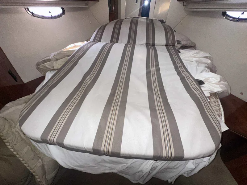 Slide: The Image of Interior cabin of 2004 Rinker Fiesta Vee 410 with striped bedding. - 29