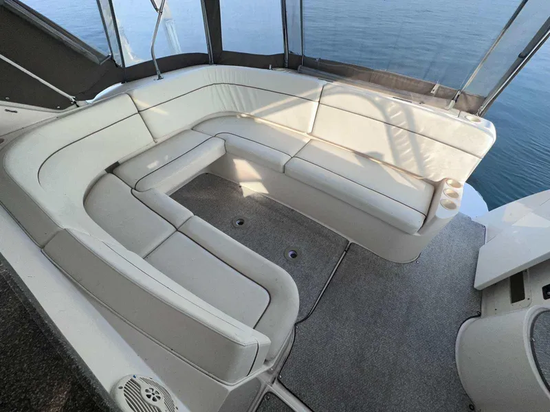 Slide: The Image of 2004 Rinker Fiesta Vee 410 boat interior with spacious white seating area. - 3