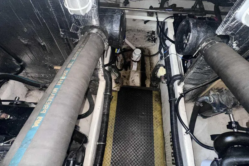 Slide: The Image of Engine room of 2004 Rinker Fiesta Vee 410 with visible hoses and components. - 34