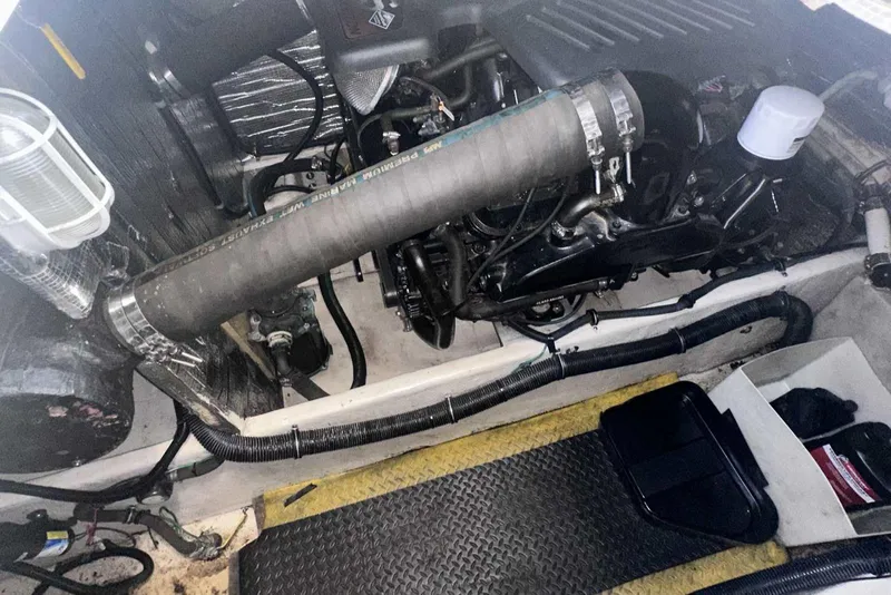 Slide: The Image of Engine compartment of a 2004 Rinker Fiesta Vee 410 boat, showing hoses and components. - 35