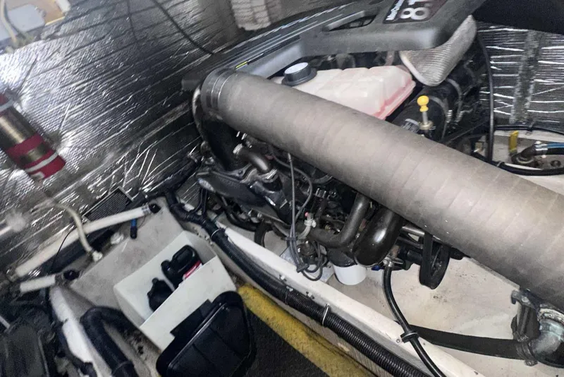 Slide: The Image of Engine compartment of 2004 Rinker Fiesta Vee 410 boat, showcasing mechanical components. - 36