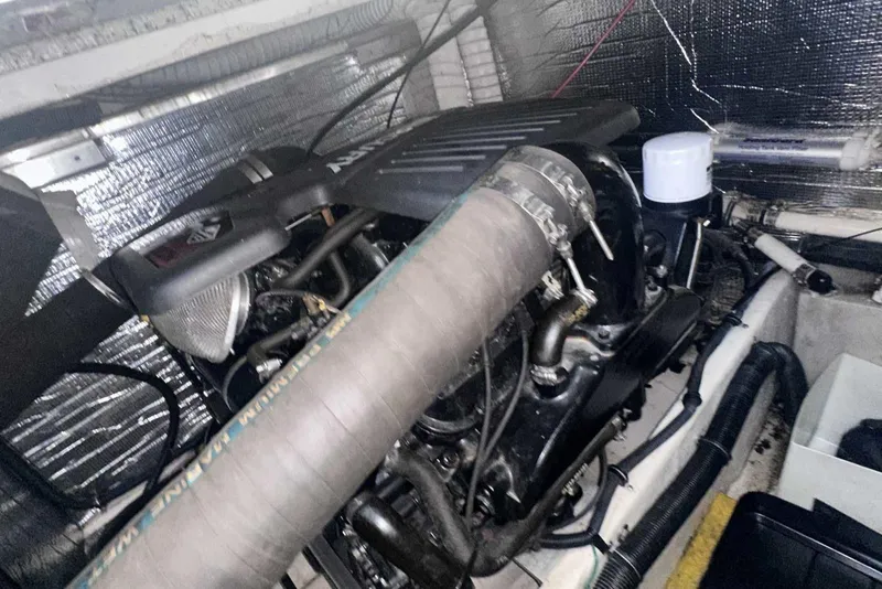 Slide: The Image of Engine compartment of a 2004 Rinker Fiesta Vee 410 boat, showcasing mechanical components. - 37