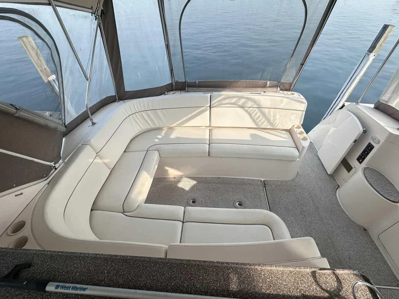 Slide: The Image of 2004 Rinker Fiesta Vee 410 boat interior with beige seating and carpeted floor. - 4